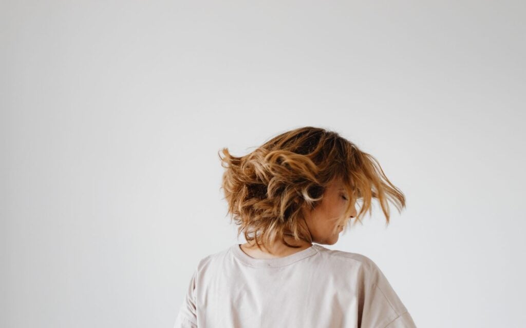 young woman doing a hair flip